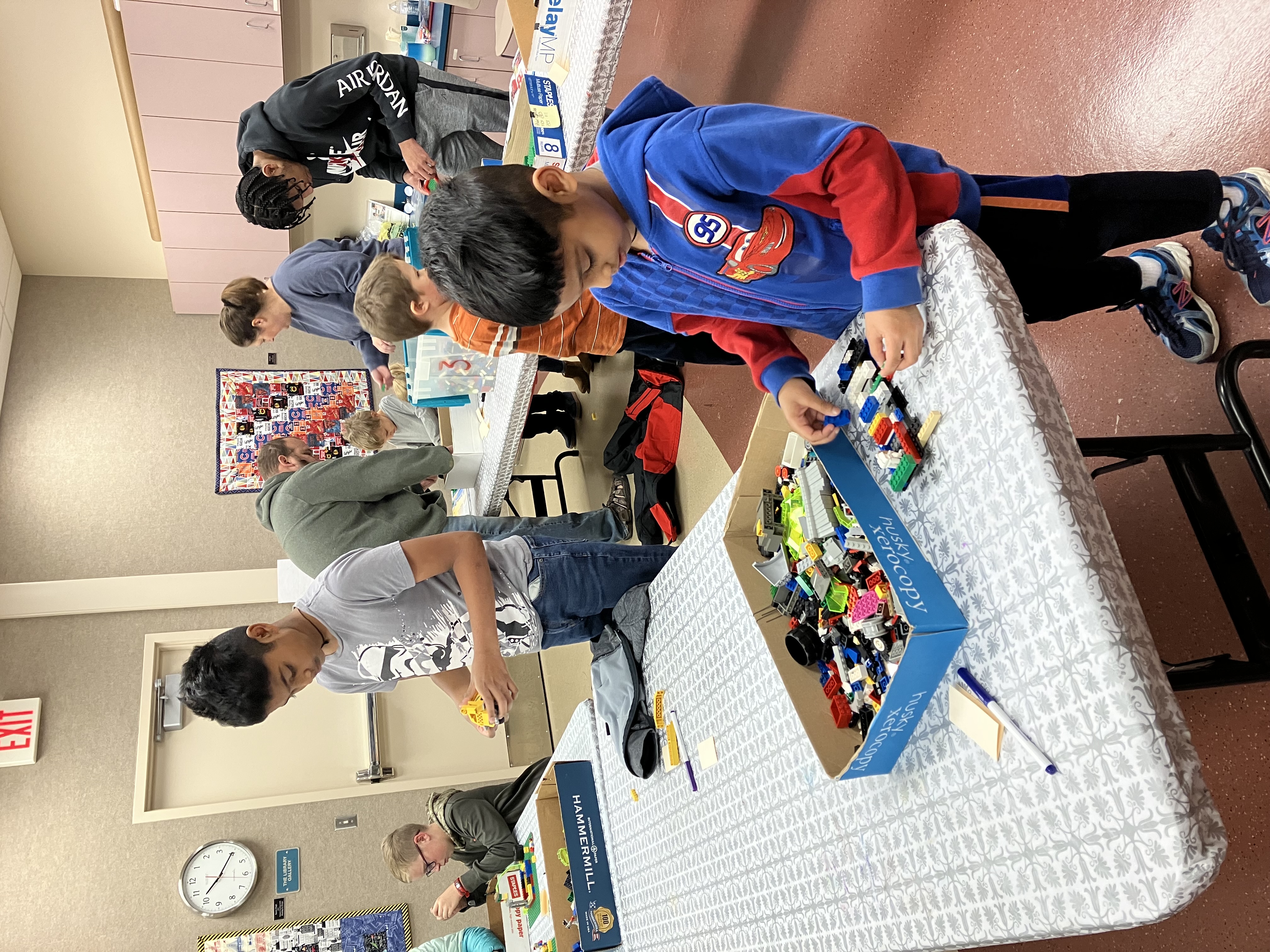 two school age boys play with legos